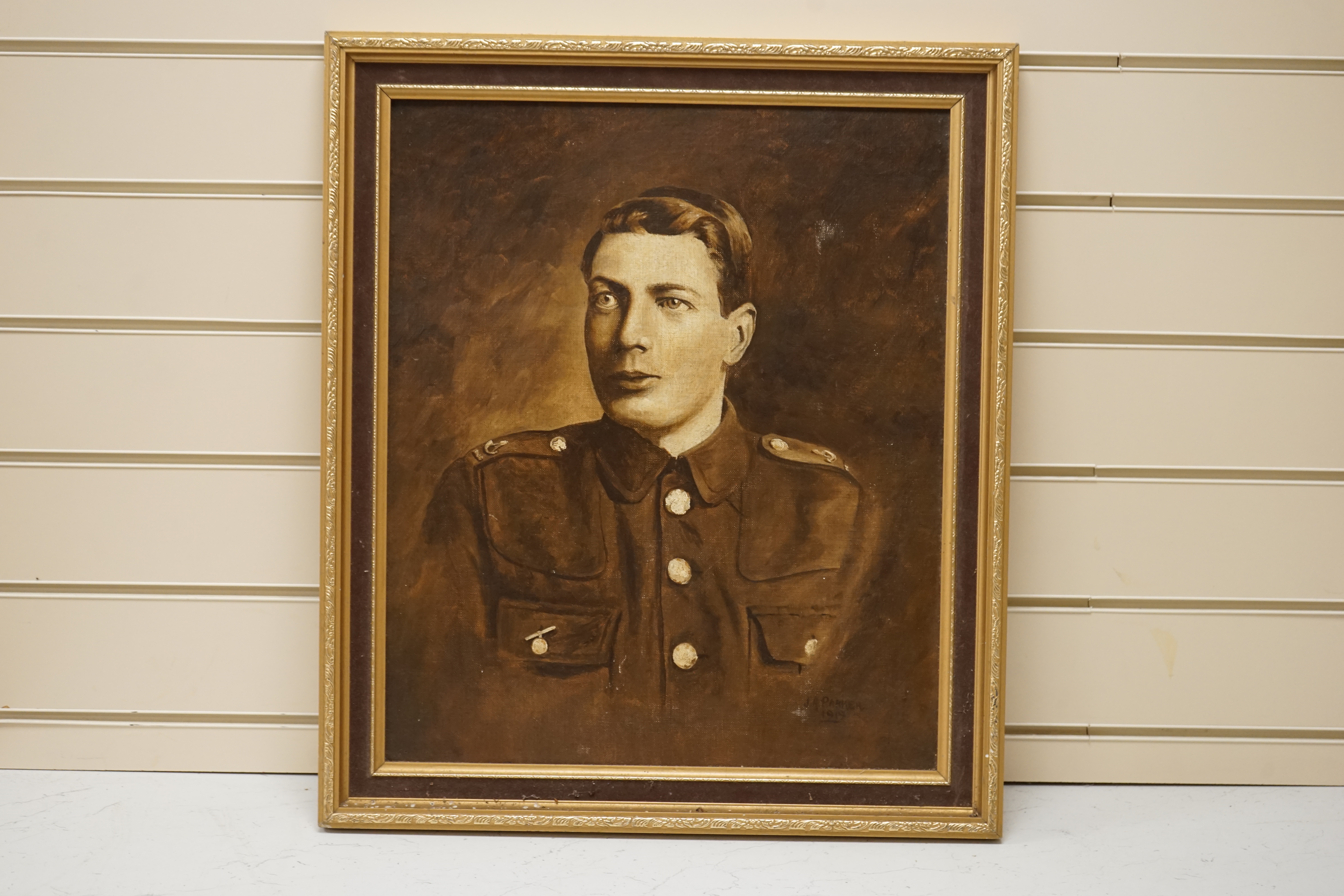 J. R. Parker, WWI interest, monochrome oil on canvas board, Portrait of a gentleman wearing military dress, signed and dated 1919, inscribed Ernest Parker verso, 47 x 39cm. Condition - fair